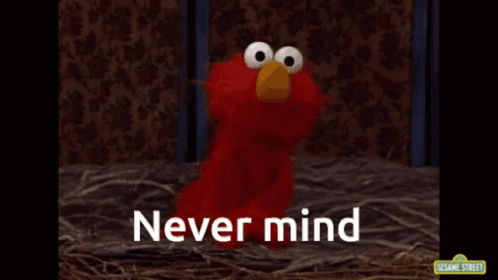 Elmo From Sesame Street Is Sitting In A Nest With The Words Never Mind Above Him GIF
