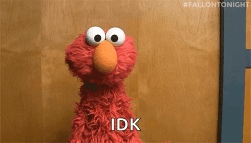 Elmo From Sesame Street Is Sitting In Front Of A Wooden Wall And Says Idk . GIF
