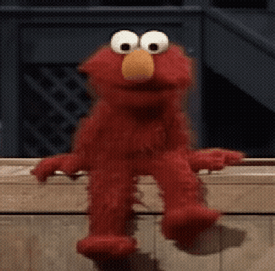 Elmo From Sesame Street Is Sitting On A Wooden Bench . GIF