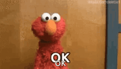 Elmo From Sesame Street Is Standing In Front Of A Door And Saying `` Ok '' . GIF