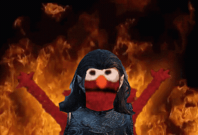 Elmo From Sesame Street Is Standing In Front Of A Fire Background GIF