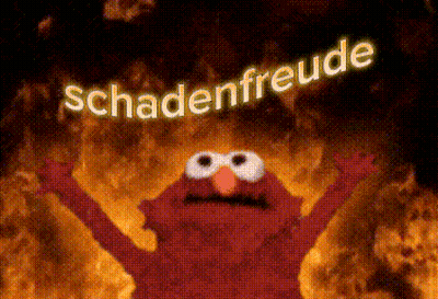 Elmo From Sesame Street Is Standing In Front Of A Fire With The Words Schadenfreude Above Him GIF