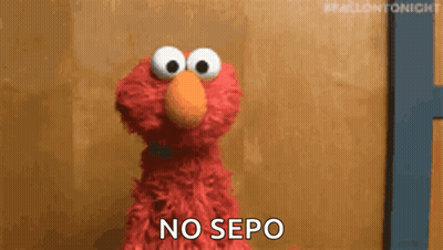 Elmo From Sesame Street Is Standing In Front Of A Wooden Wall And Saying `` No Sepo '' . GIF