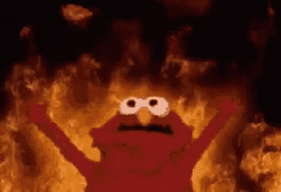 Elmo From Sesame Street Is Surrounded By Flames In A Cave . GIF