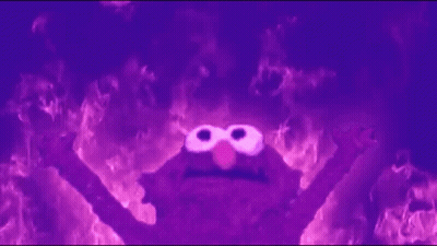 Elmo From Sesame Street Is Surrounded By Flames In A Dark Room . GIF