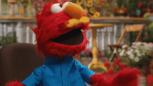Elmo From Sesame Street Is Wearing A Blue Shirt And A Blue Jacket . GIF