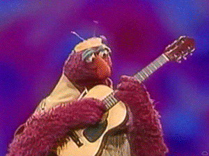 Elmo From Sesame Street Playing A Guitar On Stage GIF