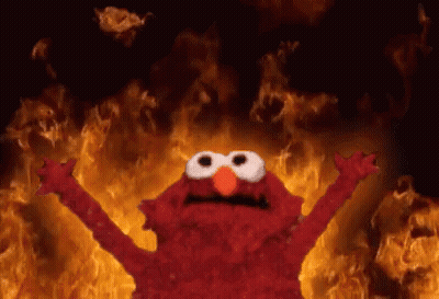 Elmo From Sesame Street Standing In Front Of Fire GIF