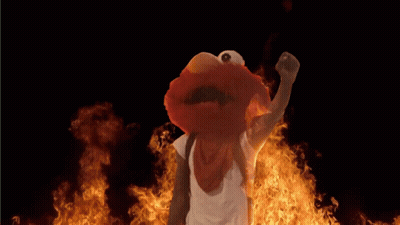 Elmo From Sesame Street Standing In Front Of Flames GIF