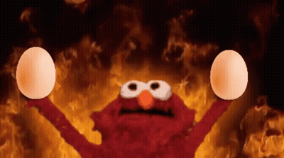 Elmo Holding Eggs In Front Of Flames GIF
