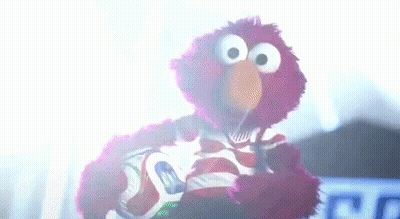 Elmo Holding Soccer Ball In Dark Room GIF