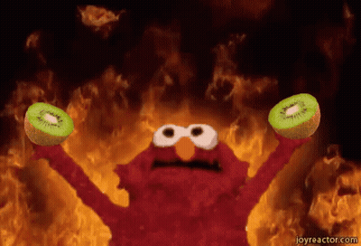 Elmo Holding Two Kiwi Fruits By Fire GIF