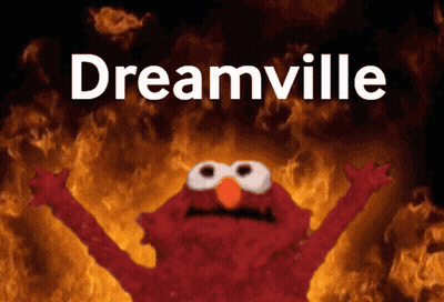 Elmo Is Standing In Front Of A Fire And The Word Dreamville Is Above Him GIF