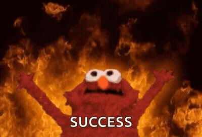 Elmo Is Standing In Front Of A Fire And The Word Success Is On The Bottom GIF