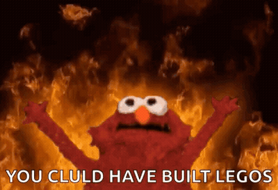 Elmo Is Standing In Front Of A Fire With His Arms Outstretched . GIF