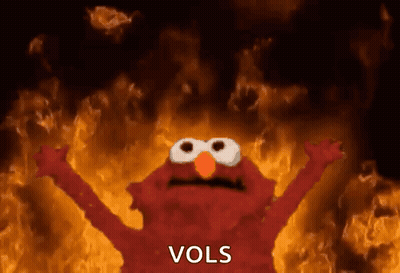 Elmo Is Standing In Front Of A Fire With The Word Vols Written On The Bottom GIF