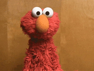 Elmo Says It 'S A Friday Thing In Front Of A Brown Wall GIF