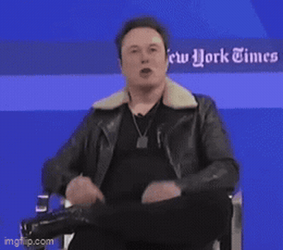Elon Musk Sitting In Front Of Blue Wall GIF