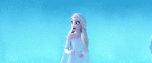 Elsa From Frozen 2 Is Standing In The Snow Wearing A White Dress . GIF