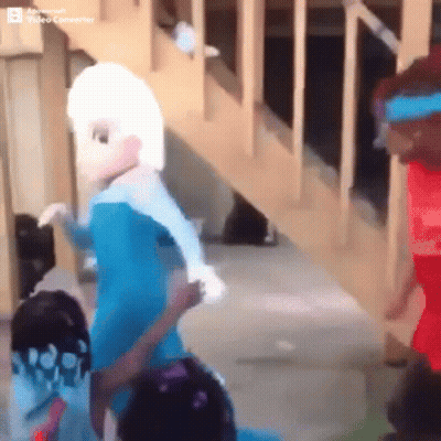 Elsa From Frozen Standing Next to Two Children