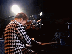 Elton John Stretching Both Arms GIF