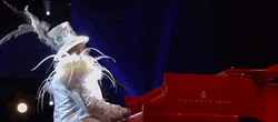 Elton John Wearing Matching White Outfit And Hat GIF