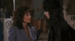 Elvira Going Past Anchorwoman GIF
