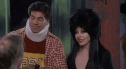 Elvira Kissing A Man On The Forehead GIF