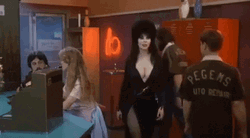 Elvira Looking Around And Smirking GIF