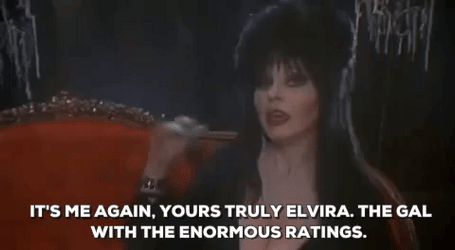 Elvira Waving And Introducing Herself GIF