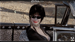 Elvira Waving Hello From Her Car GIF