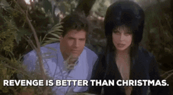 Elvira With Bob Redding In The Bushes GIF