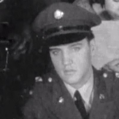 Elvis Presley In Black And White Military Uniform And Hat GIF