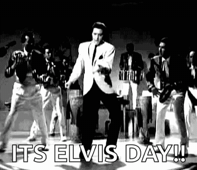 Elvis Presley Is Dancing On Stage In A Black And White Photo With A Band Behind Him . GIF