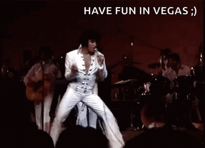 Elvis Presley Is Dancing On Stage In Front Of A Crowd While Playing A Guitar . GIF