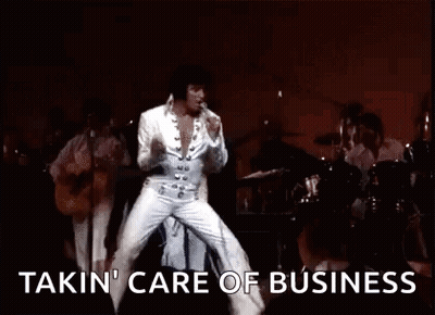 Elvis Presley Is Dancing On Stage While Playing A Guitar And Singing . GIF