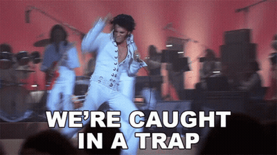 Elvis Presley Is Dancing On Stage With The Words We 'Re Caught In A Trap Below Him GIF