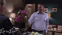 Embarrassed Man Giving Flowers GIF