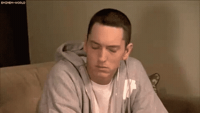 Eminem On Couch Wearing Headphones And Hoodie GIF