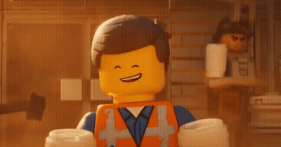 Emmett From The Lego Movie Smiling Holding Headphones Over Head GIF