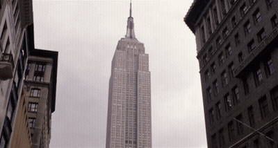 Empire State Building Surrounded By Tall Buildings GIF