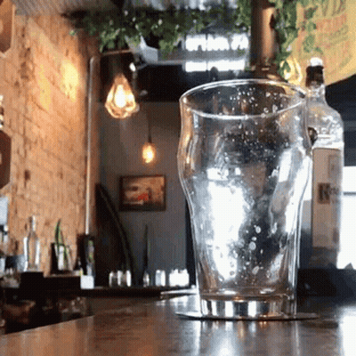 Empty Glass On Coaster At Restaurant Counter GIF