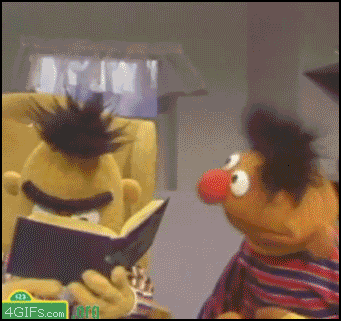 Ernie And Bert Looking At A Book GIF