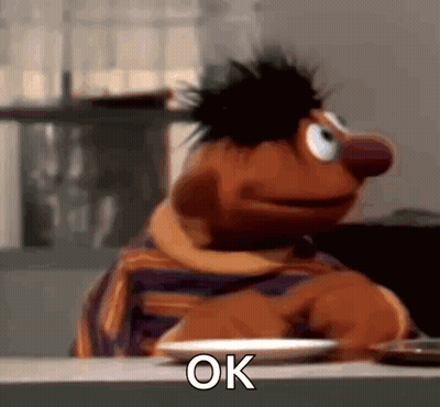Ernie Sitting At Table With Plate Of Food GIF