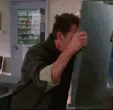Exasperated Man Bangs Head Against Wall GIF