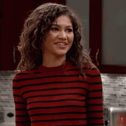 Fake Smile Shrugging Zendaya GIF