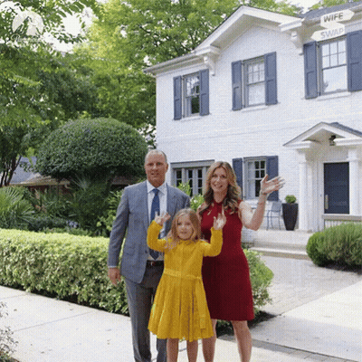 Family In Front Of House With Wife Swap Sign GIF