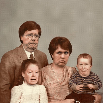 Family Posing With Drawn Faces GIF