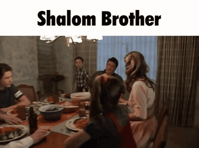 Family Sitting Around Table Saying Shalom Brother GIF