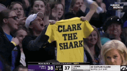 Fan Displaying Caitlin Clark Jersey GIF
